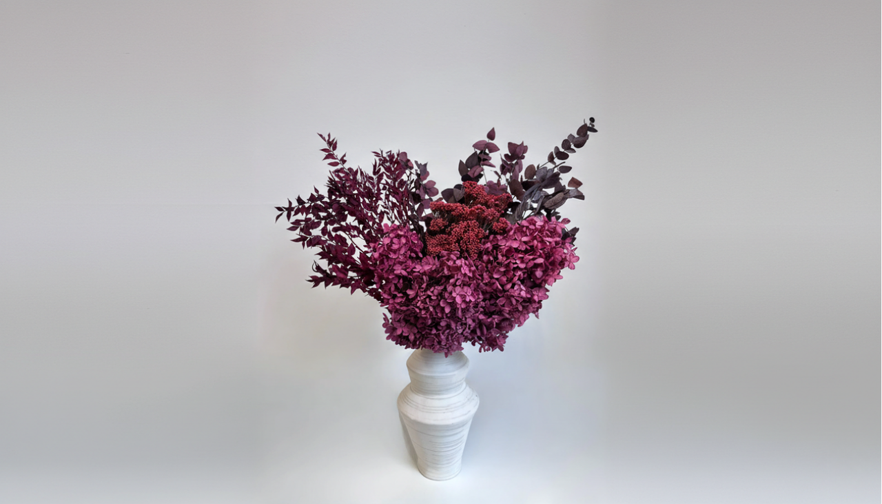 A grand foyer featuring Nordblooms Permanent Botanical Architecture; a large-scale preserved peony masterpiece on a marble console in a sun-drenched luxury home.